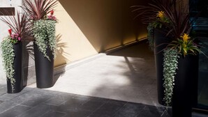The entrance to Scandic Paas, featuring a modern sign and potted plants. - Scandic Paasi (Helsinki)