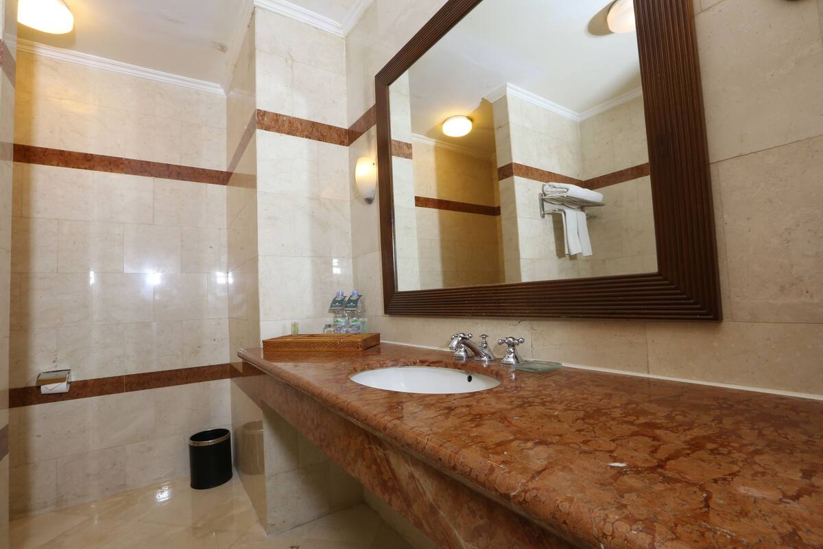 Shower, hair dryer, slippers, towels