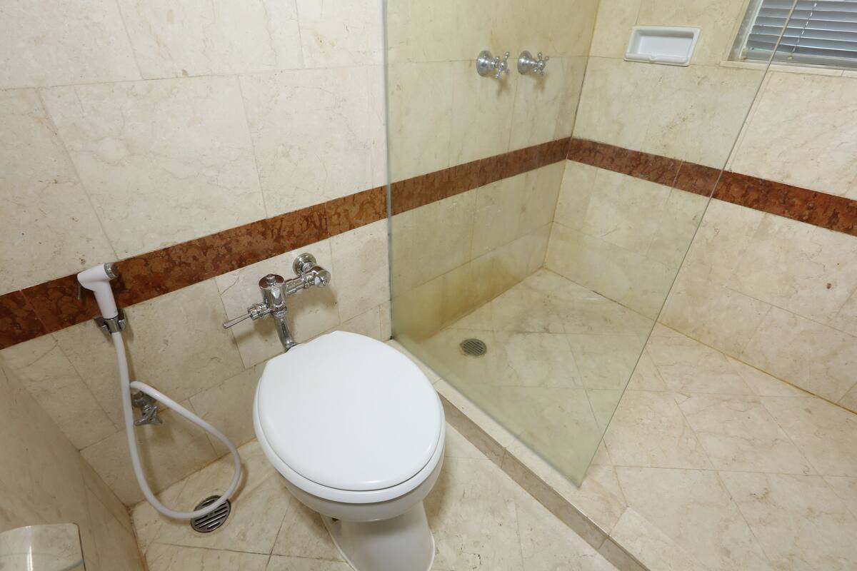 Shower, hair dryer, slippers, towels