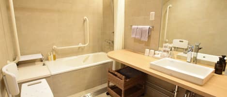 A modern bathroom with a bathtub, two sinks, a shower, and a wheelchair-accessible bench.