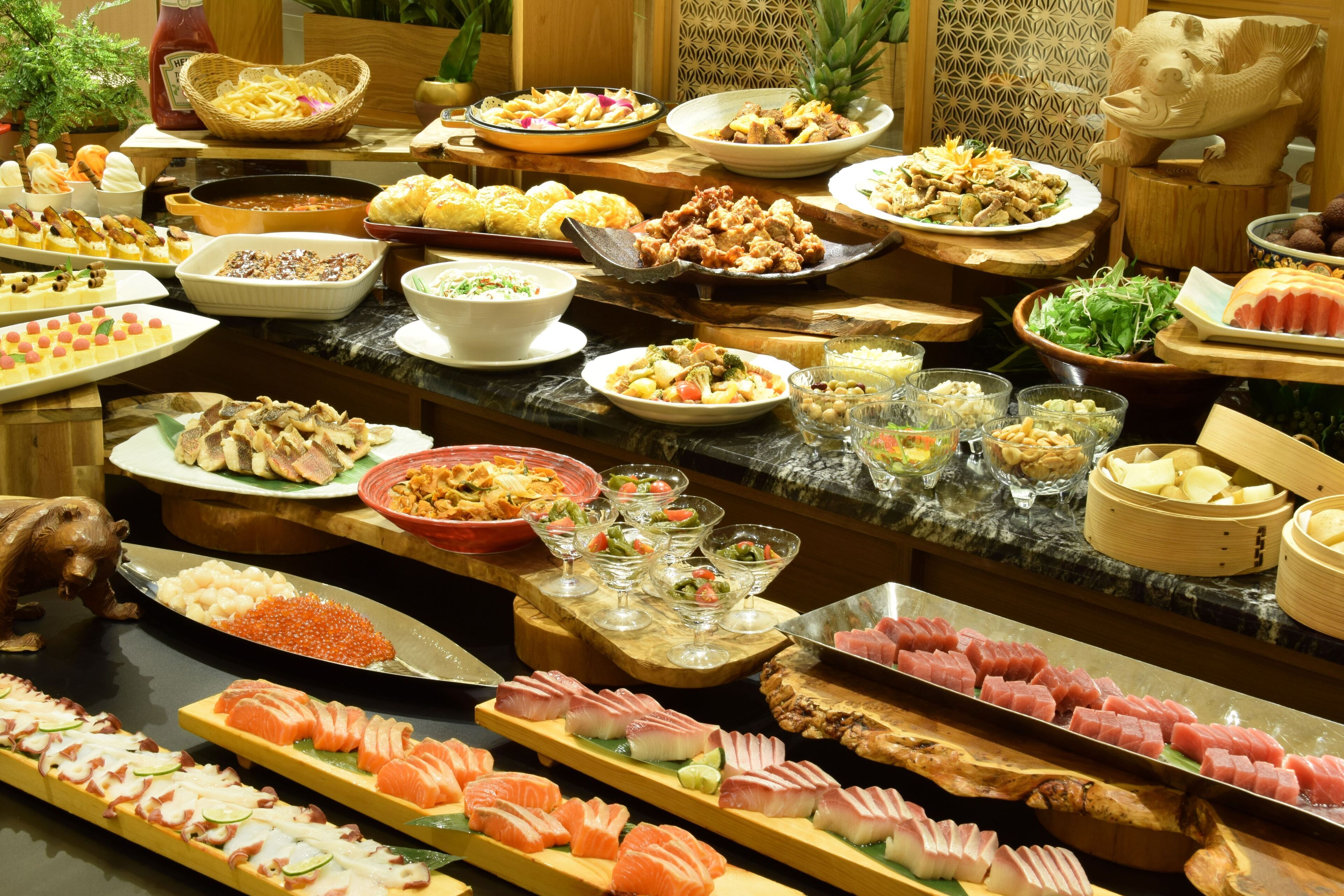 A buffet with various dishes and seafood.