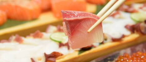 A close-up of a sushi dish with various toppings.