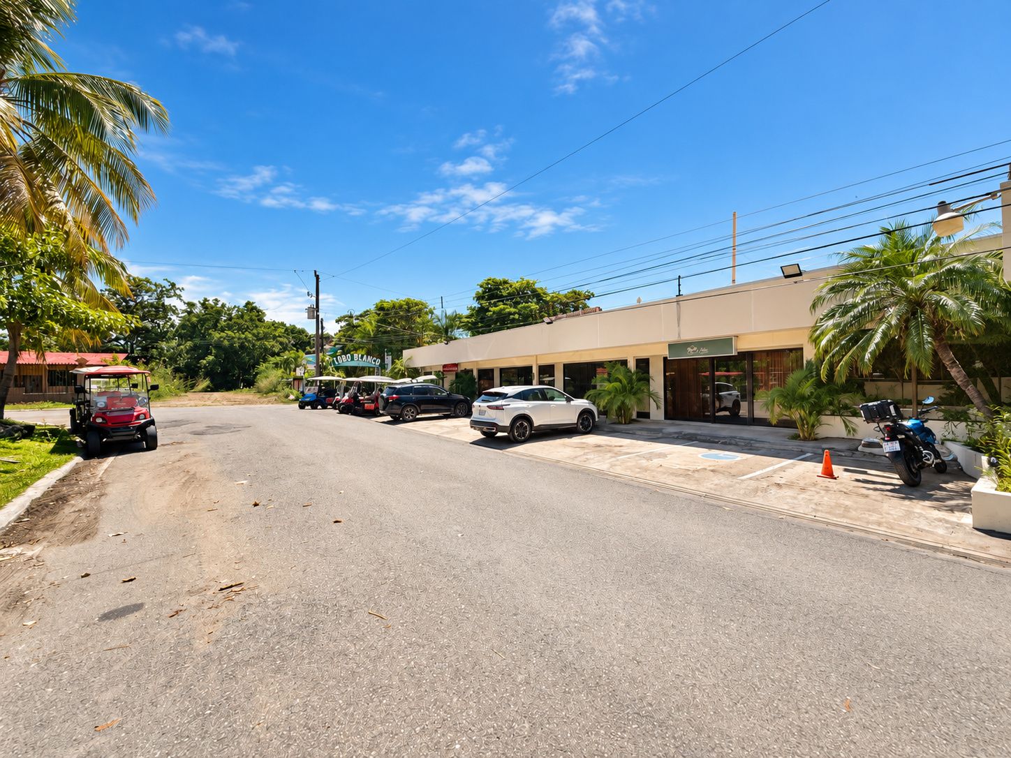 A street view with a building that has a sign reading 'LOBO BLANCO'.