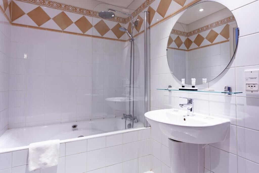 deluxe triple room | bathroom | hair dryer, bathrobes, towels