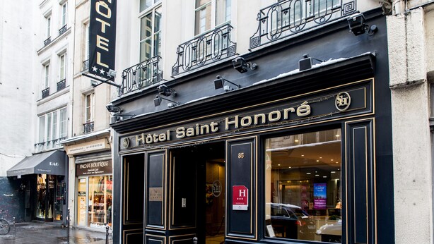 The exterior of Hotel Saint Honoré with a classic facade, large windows, and a visible entrance. - Hotel Saint Honore 85 (Paris)