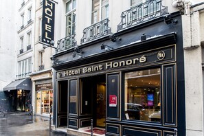 The exterior of Hotel Saint Honoré with a classic facade, large windows, and a visible entrance. - Hotel Saint Honore 85 (Paris)
