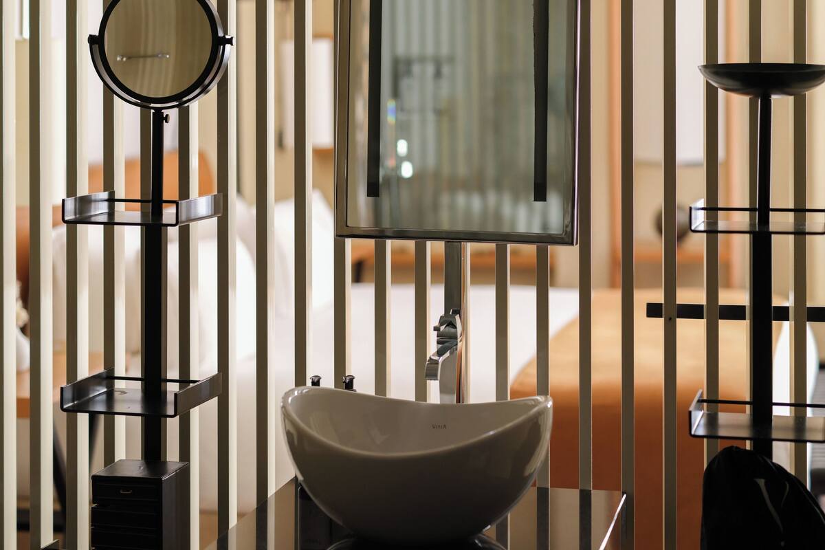 junior suite | bathroom | rainfall showerhead, designer toiletries, hair dryer, bathrobes