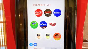 A digital menu with various drink options including Coca-Cola, Fanta, and others.
