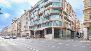 A multi-story hotel with a modern design, featuring balconies, large windows, and a prominent entrance. - NH Collection Budapest City Center (Budapest)