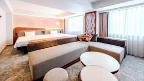 A modern hotel room with a large bed, a sofa, and a small table. - Richmond Hotel Fukuoka Tenjin (Fukuoka)