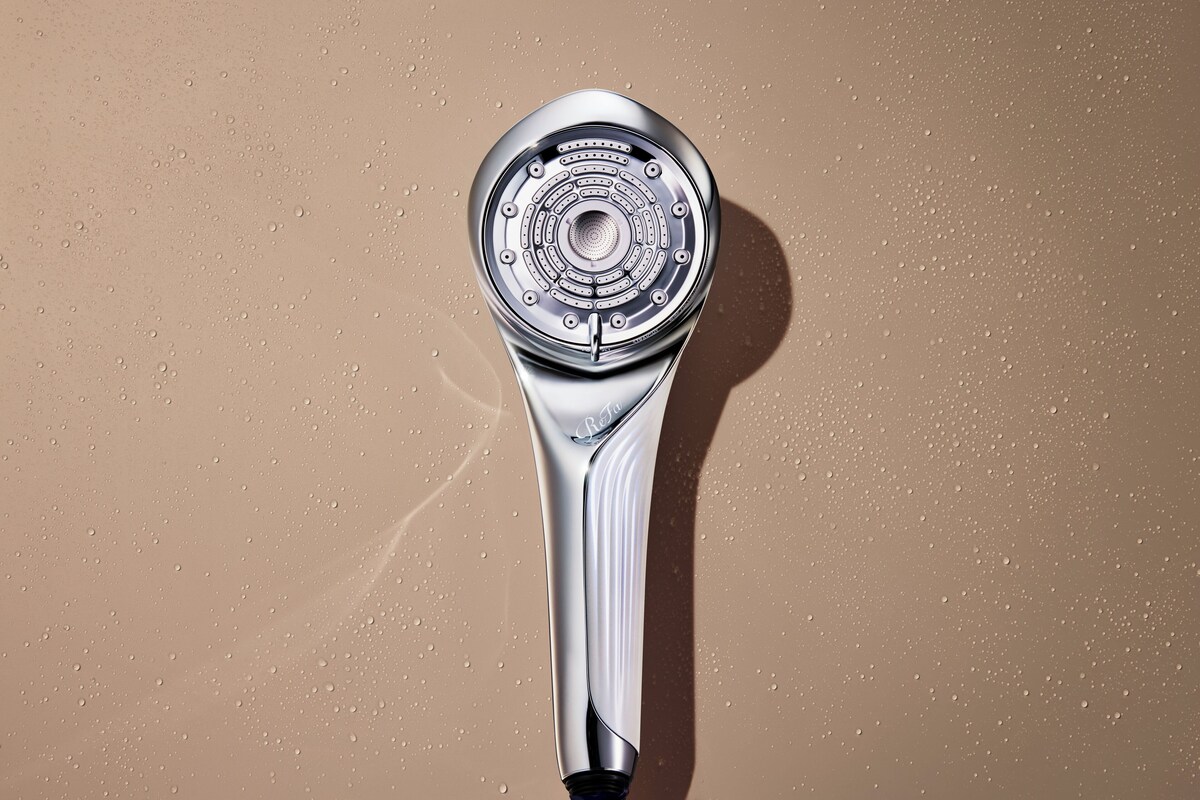 A showerhead with a circular design and a metallic finish.
