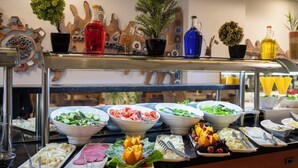 A buffet with various food items and decorative elements. - Buyuk Velic Hotel (Gaziantep)