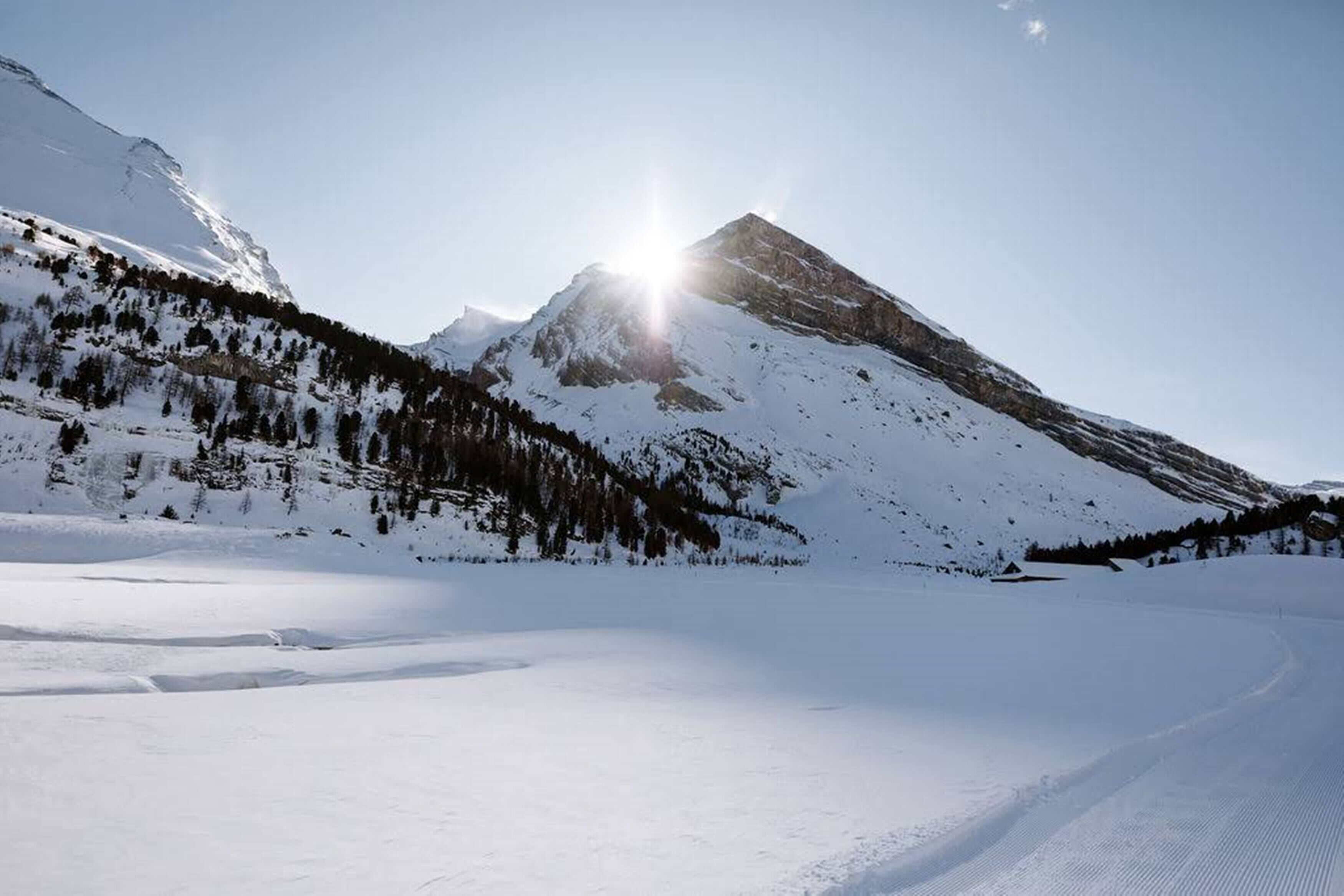 A snow-covered mountain landscape with a clear sky.