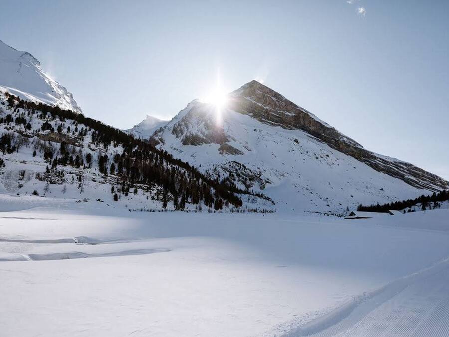 A snow-covered mountain landscape with a clear sky.