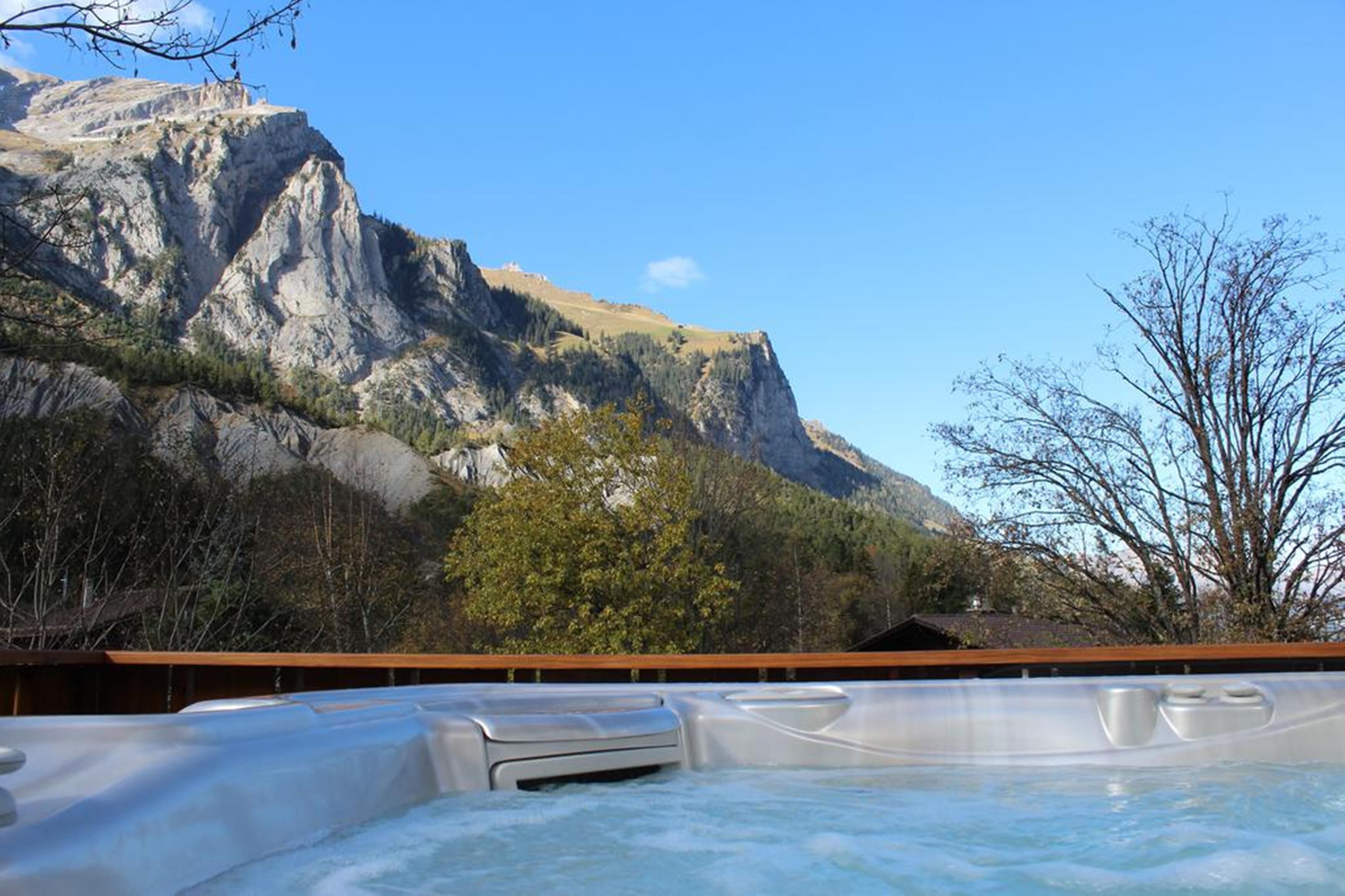 A hot tub with a mountain backdrop.