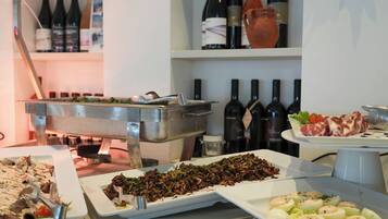 A buffet with various dishes, including meat, vegetables, and eggs, and a selection of wine bottles on shelves in the background.