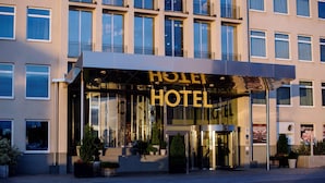 A hotel entrance with a glass facade, a prominent 'HOTEL' sign, and potted plants at the entrance. - Best Western Plus Sthlm Bromma (Bromma)