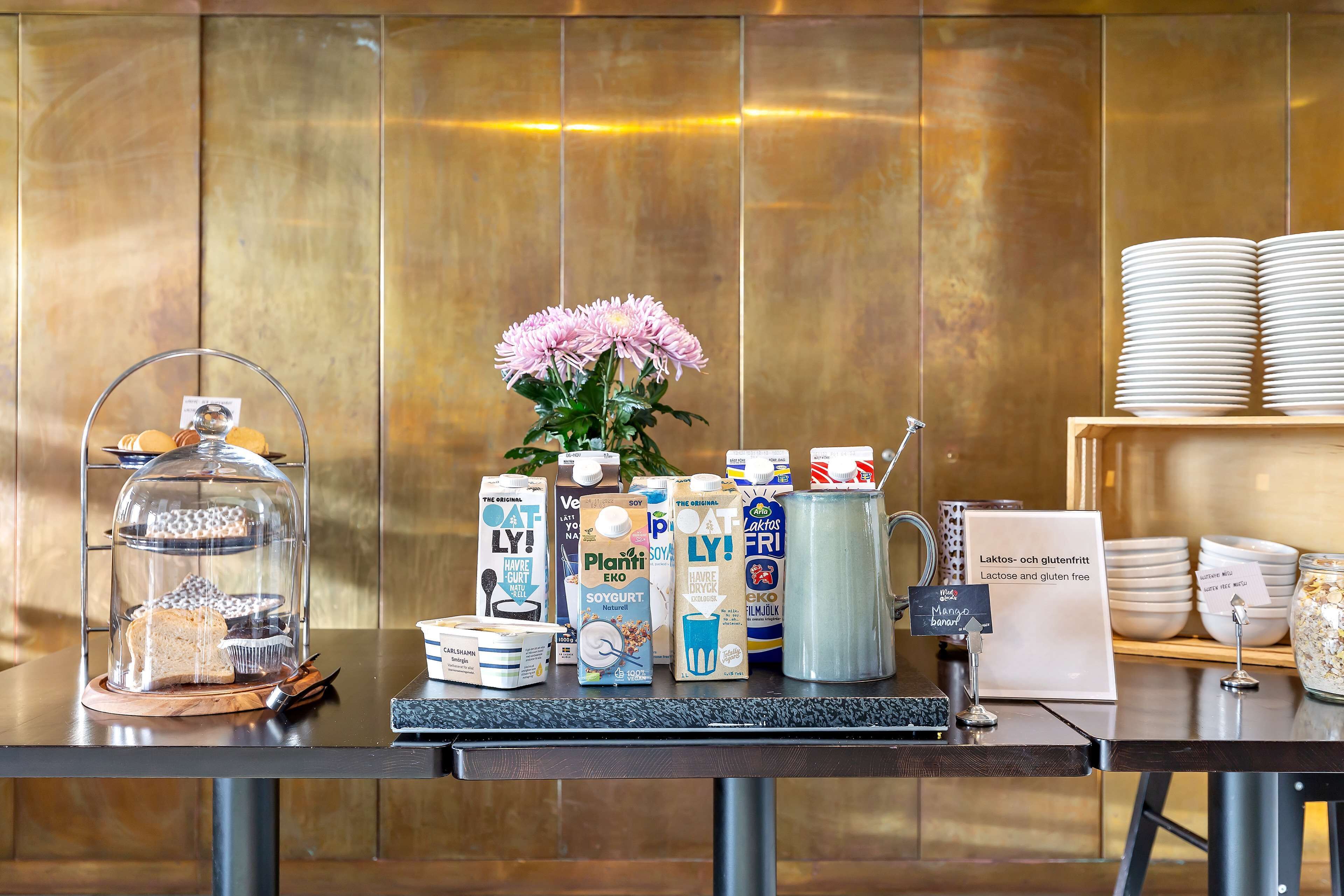 A breakfast buffet with various food items, including pastries, dairy products, and beverages.