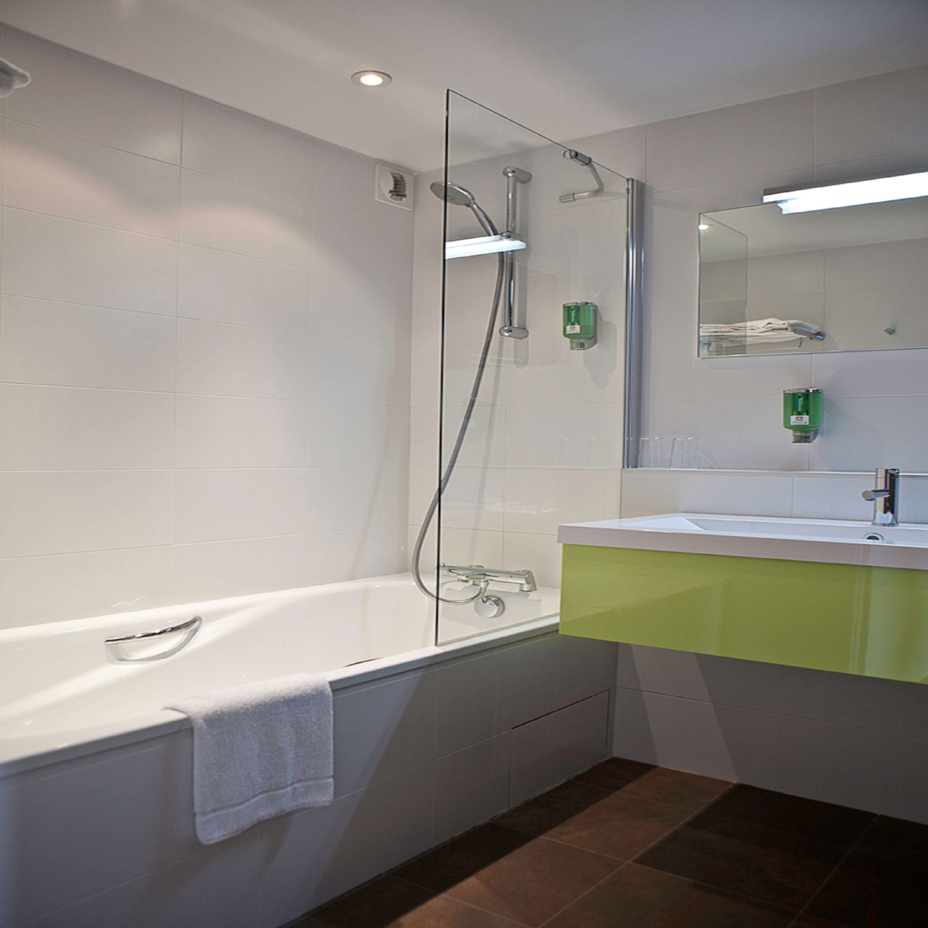 bathtub, hair dryer, bathrobes, towels