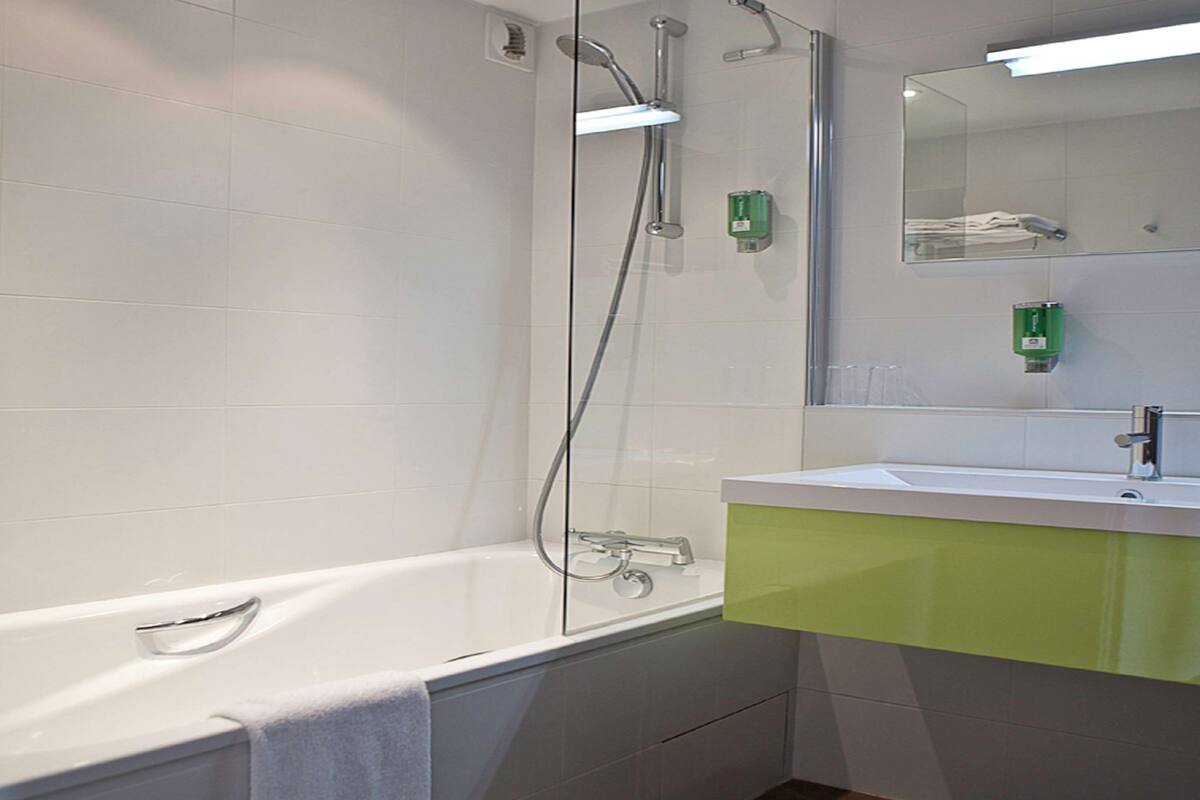 bathtub, hair dryer, bathrobes, towels