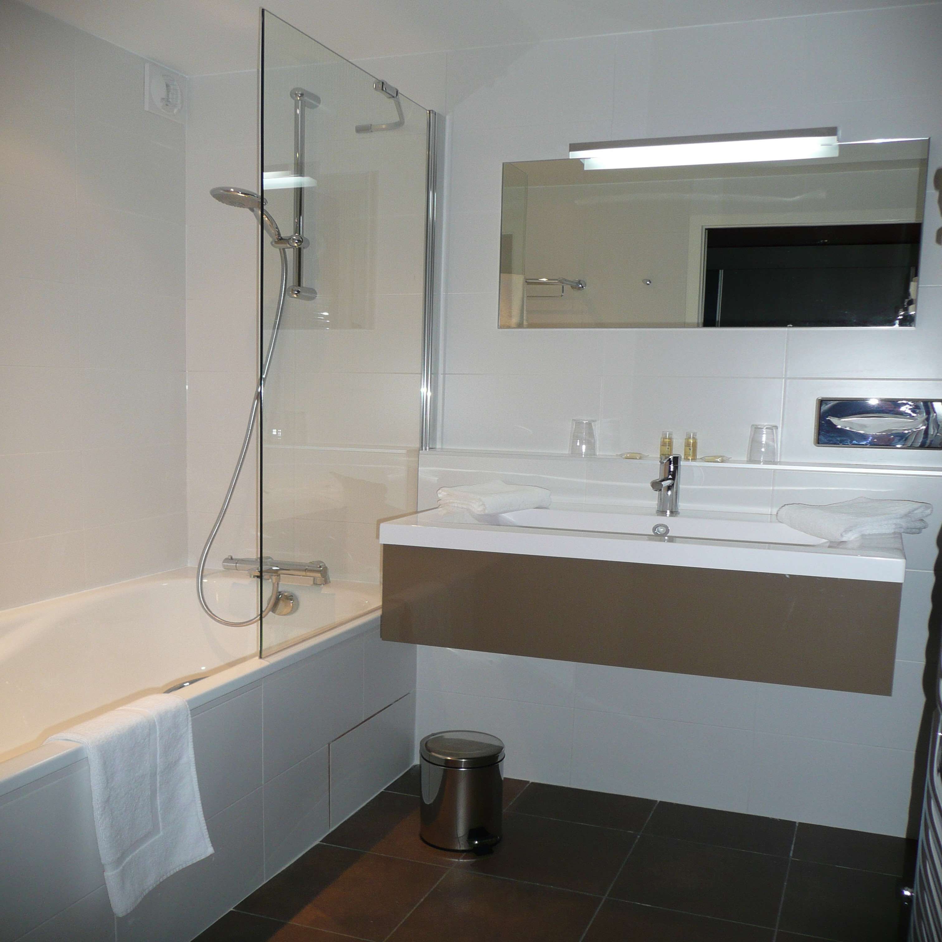 bathtub, hair dryer, bathrobes, towels