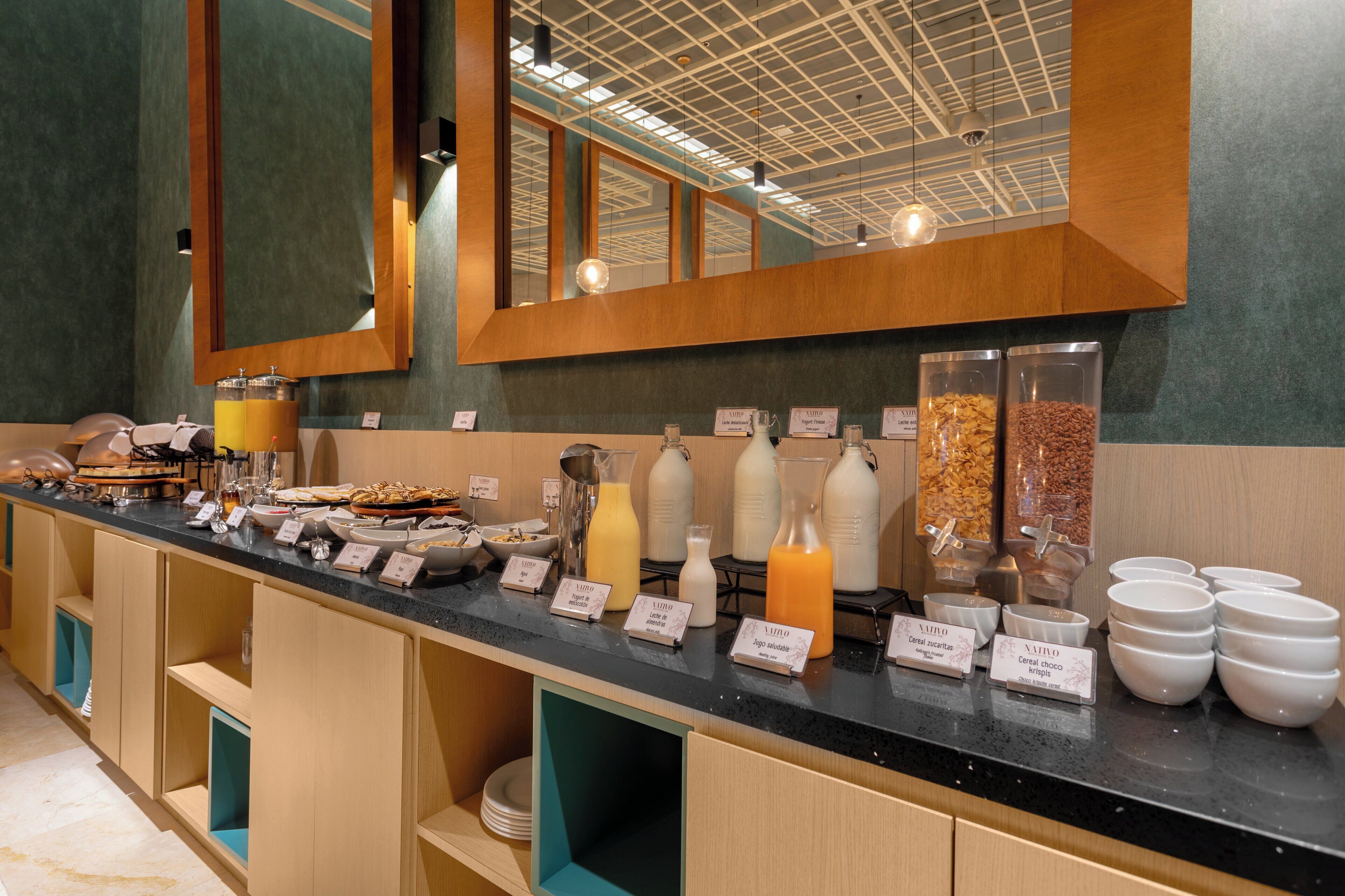 A breakfast buffet with various food items and beverages.