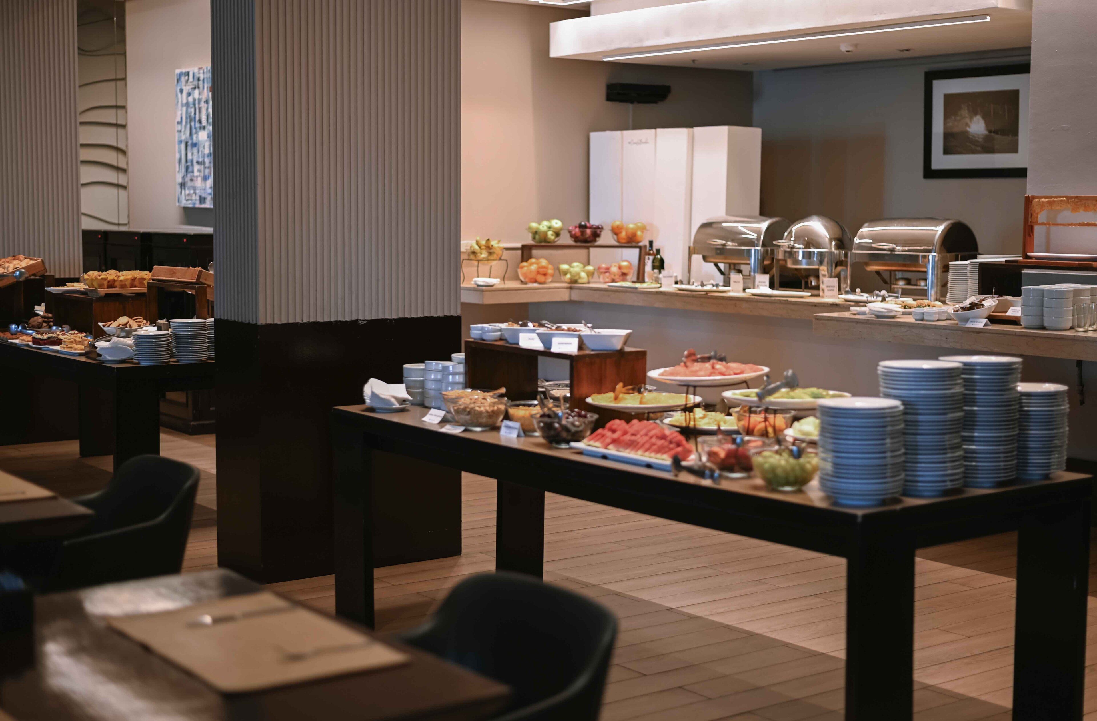A buffet setup with various food items and serving equipment.