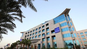 A Novotel hotel with a modern design, featuring multiple floors and a prominent entrance.