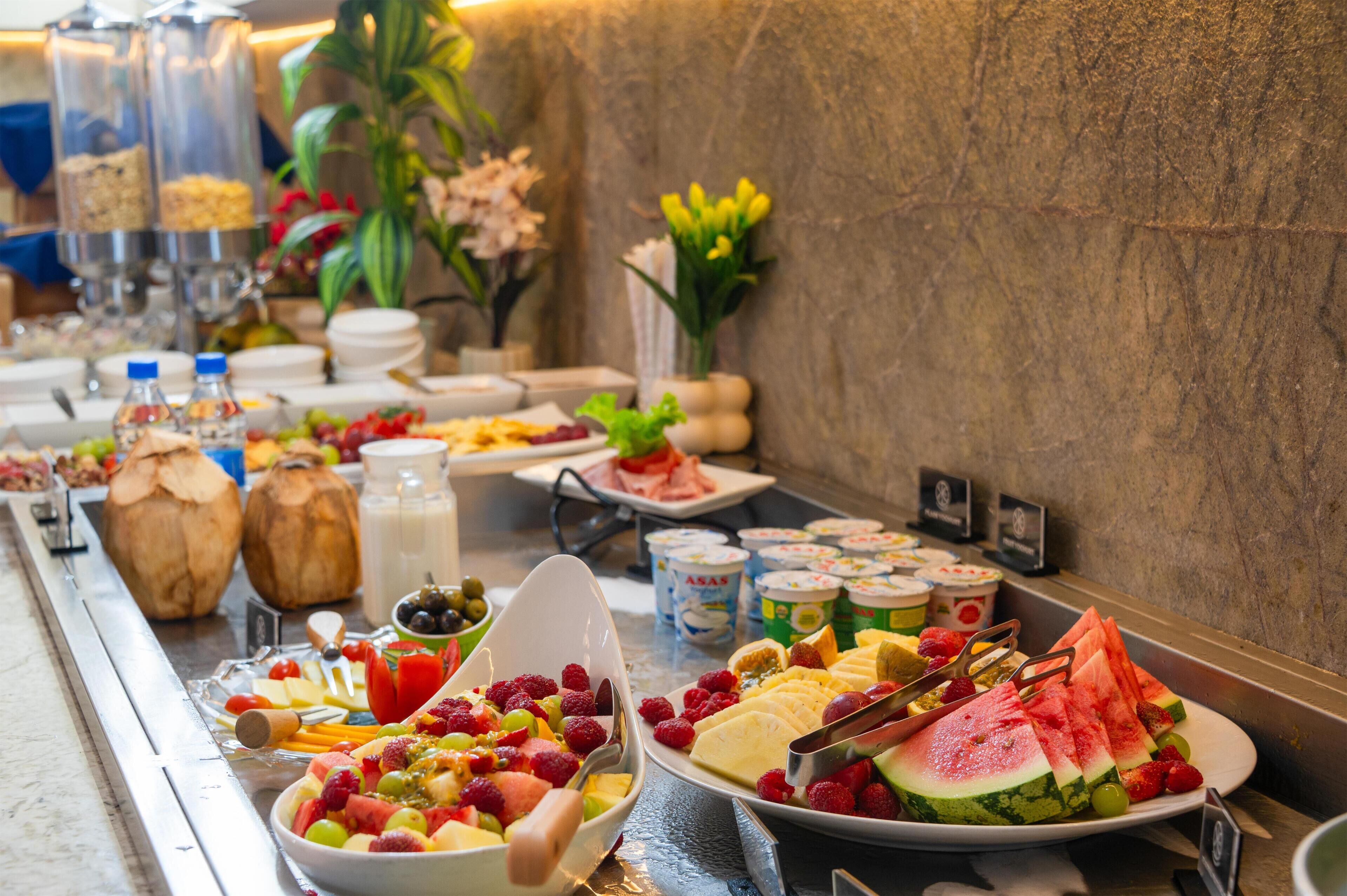 A buffet with various food items and beverages.