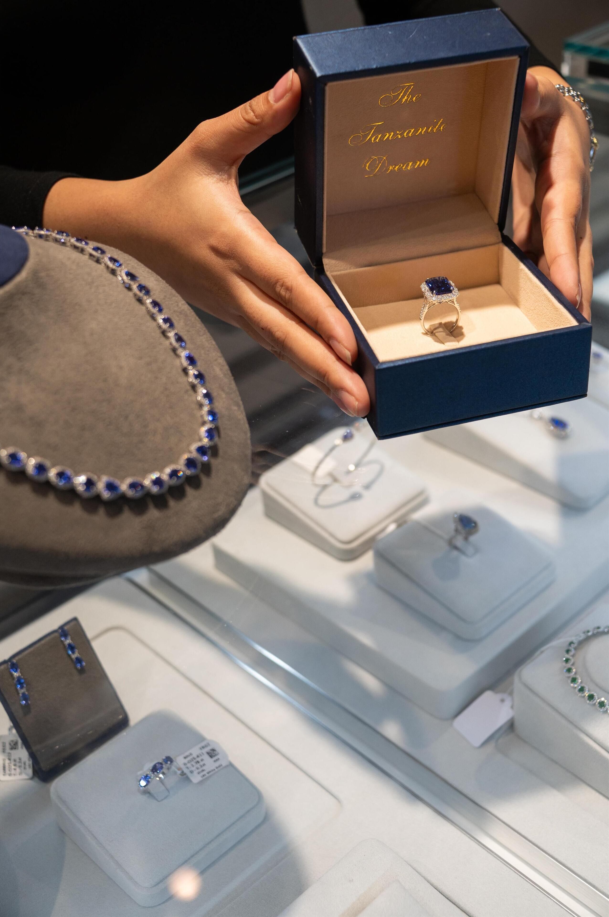 A jewelry display with a ring in a blue box labeled 'The Tanzanite Dream.'