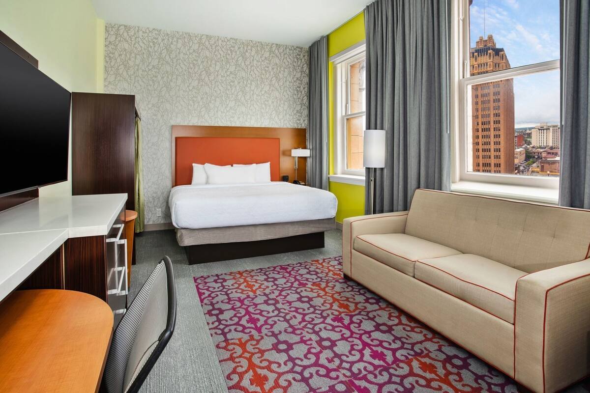Hypo-allergenic bedding, desk, laptop workspace, blackout curtains