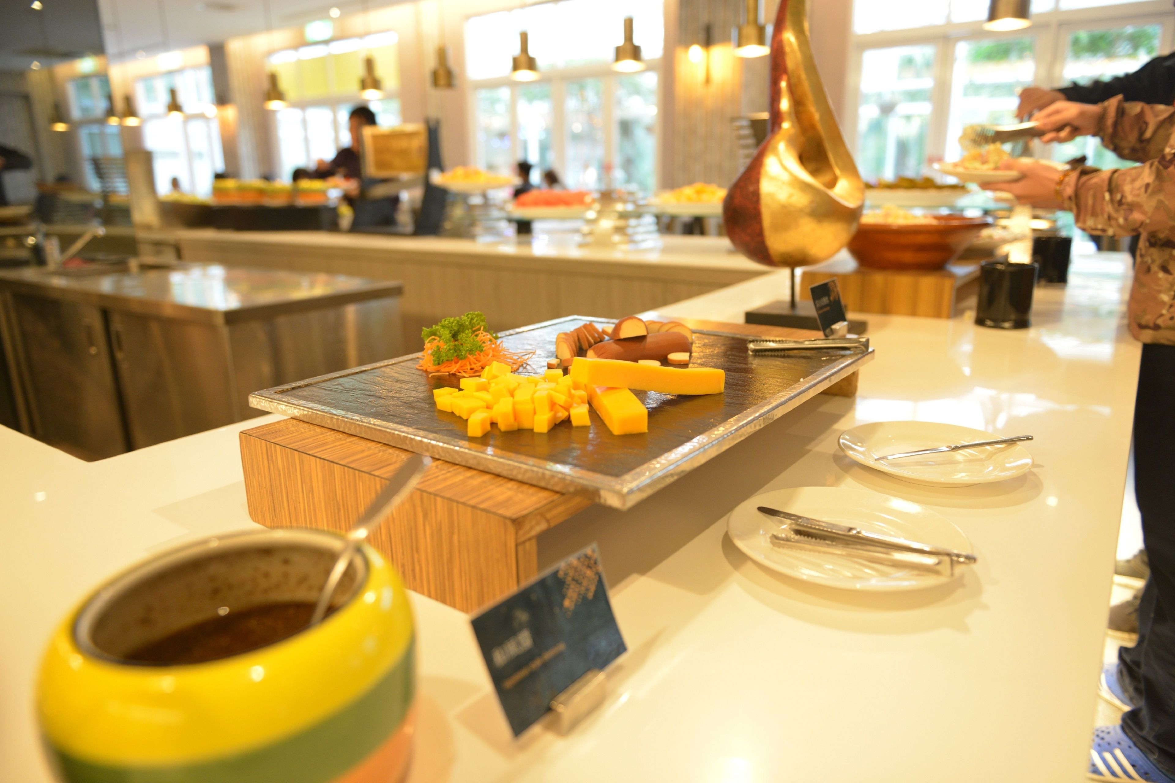 A buffet setup with various food items and utensils.