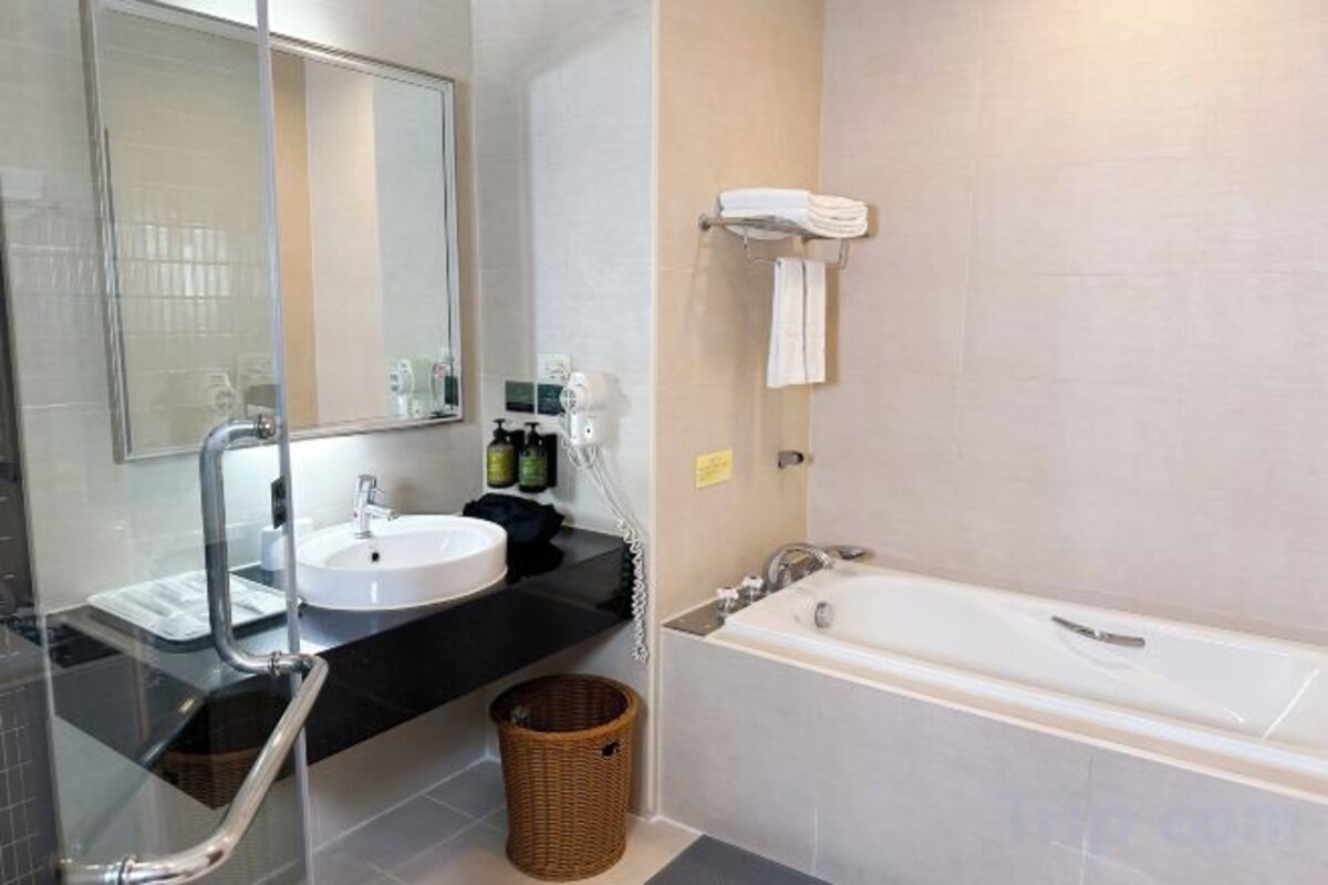 Separate tub and shower, hair dryer, slippers, towels