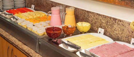 A buffet with various food items and beverages.