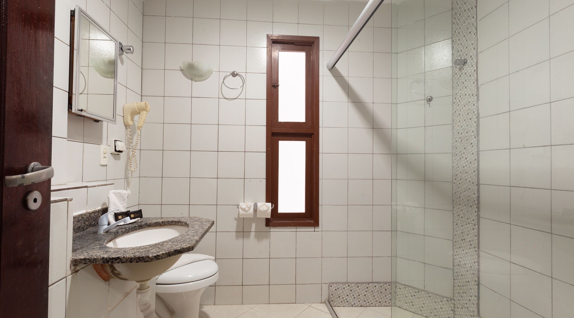 A bathroom with a sink, toilet, and shower.