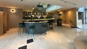 A modern bar area with a central island, bar stools, and pendant lighting. - Tequendama Hotel Medellín (Medellín)