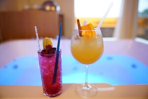 Two drinks on a table with a blurred background.