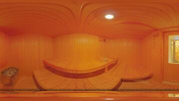A wooden interior with curved wooden benches and a small table.