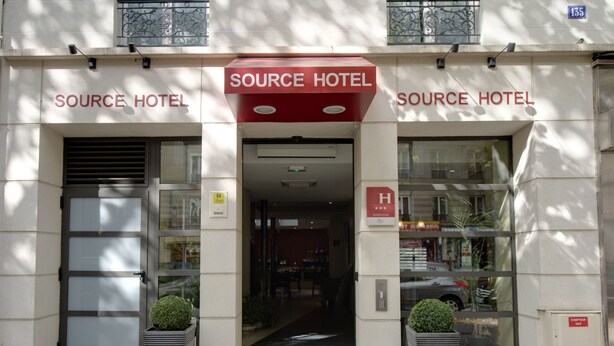 The entrance of Source Hotel with a modern facade, large glass windows, and a central entrance. - Source Hotel (Paris)