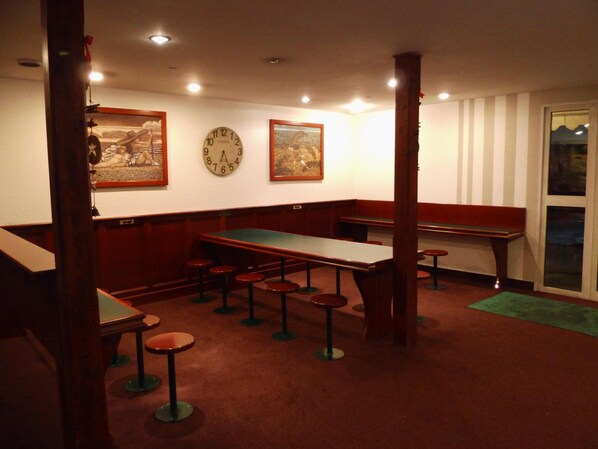 A room with a pool table, bar stools, and a clock on the wall. - Quick Palace Lyon Saint Priest (Saint-Priest)