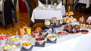 A breakfast buffet with various fruits, pastries, and beverages. - Brook Lane Hotel (Kenmare)