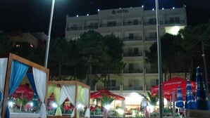 A hotel with a modern design, featuring multiple balconies and a well-lit facade. - AS Hotel (Golem)