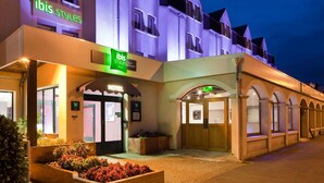A hotel with a prominent 'ibis Styles' sign, a traditional facade, and a gated entrance. - ibis Styles Blois Centre Gare (Blois)