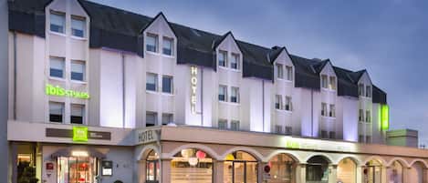 A hotel with a modern design, featuring multiple units and a prominent 'HOTEL' sign.
