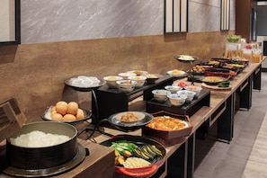 A buffet setup with various food items and a large pot of rice. - Hotel Vista Sapporo Odori (Sapporo)