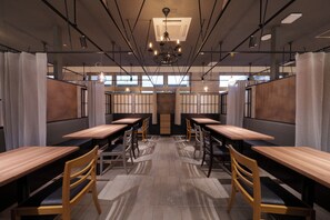 A modern restaurant interior with high tables, chairs, and a chandelier. - Hotel Vista Sapporo Odori (Sapporo)