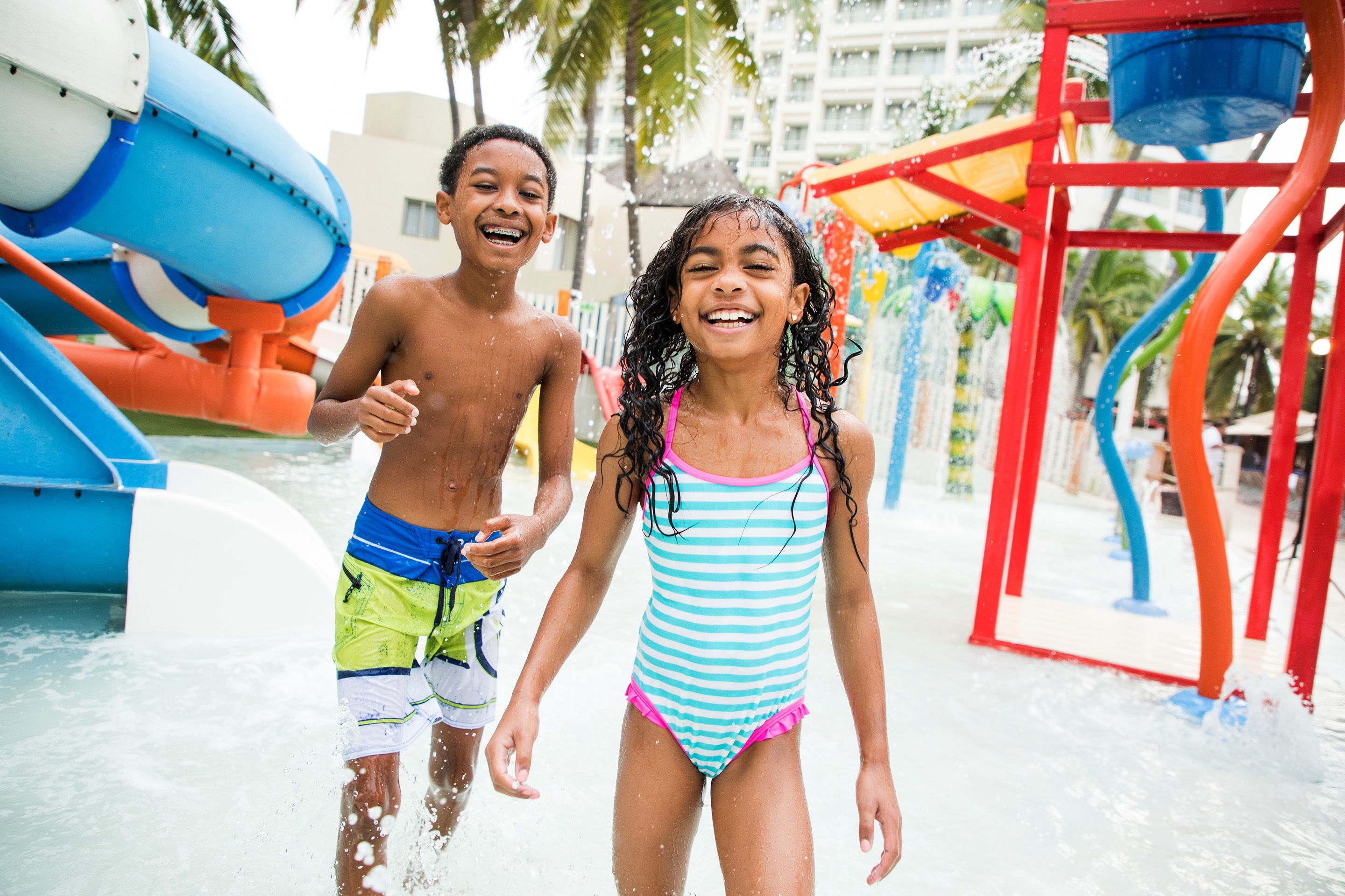 A water park with a water slide and play structures.