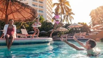 Relax by the pool surrounded by palm trees and lounge chairs.
