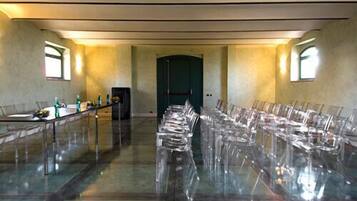 A conference room with a long table, chairs, and a door in the center.