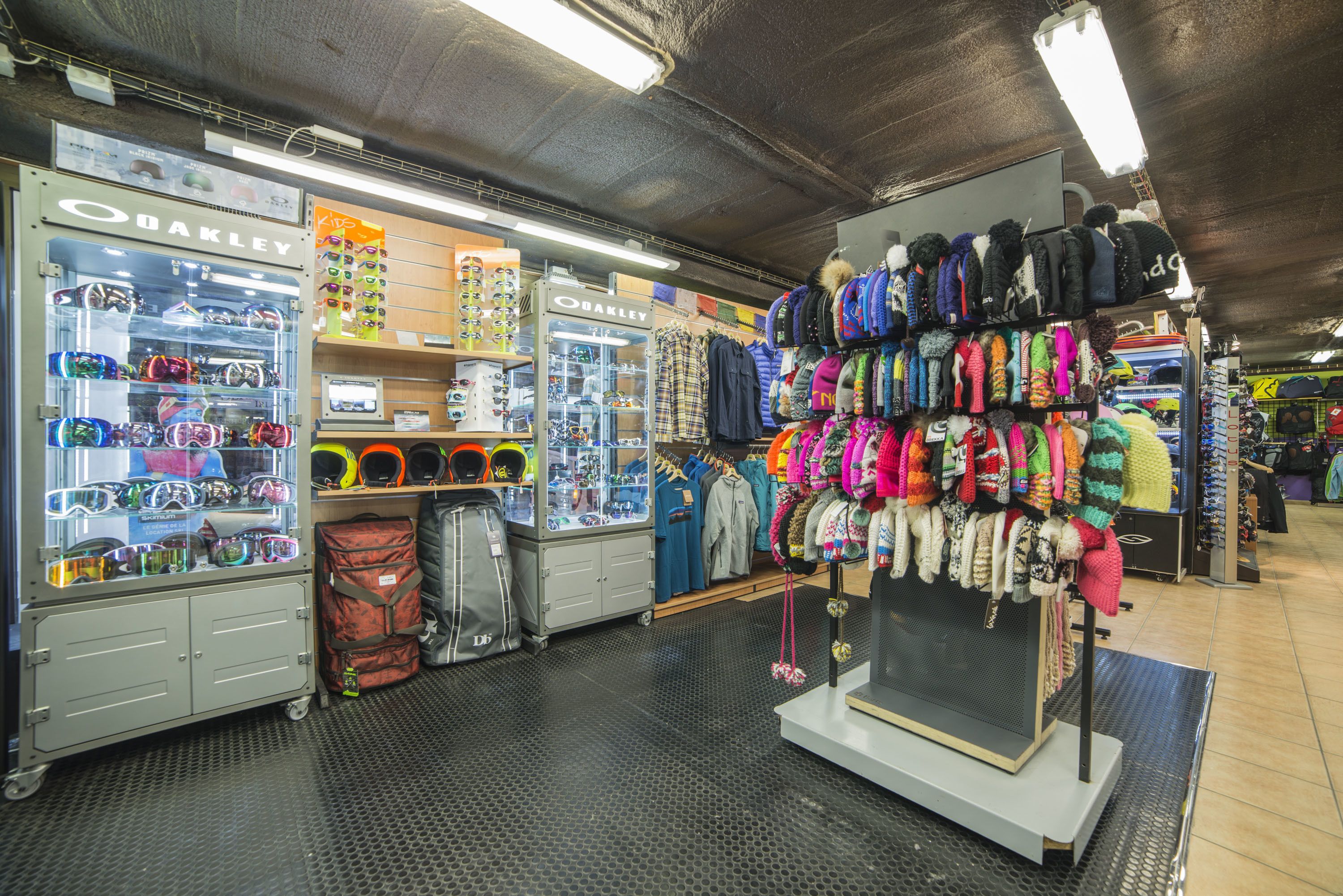 A retail store with various clothing items and accessories on display.